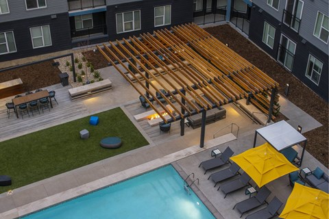 an aerial view of the pool and patio area of an apartment building