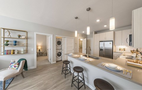 a kitchen with a breakfast bar and a laundry room