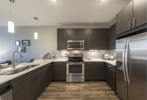 a kitchen with stainless steel appliances and wooden cabinets