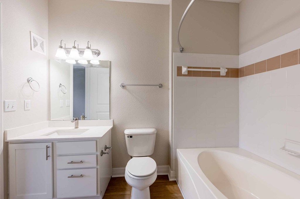 a white garage with three garage doors in a parking lot