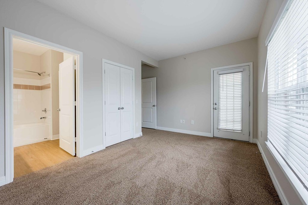 a covered porch with windows and a balcony