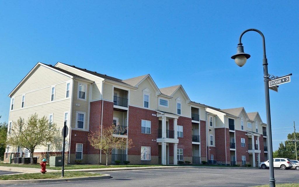 a row of apartment buildings on a street corner