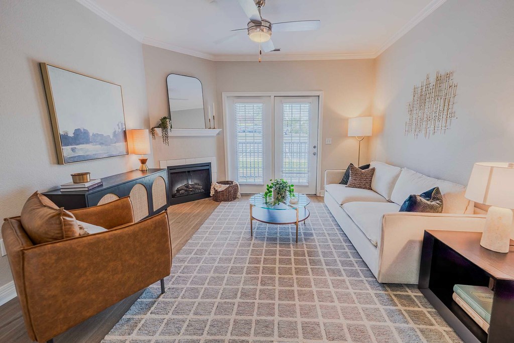A room with a carpeted floor and a ceiling fan.