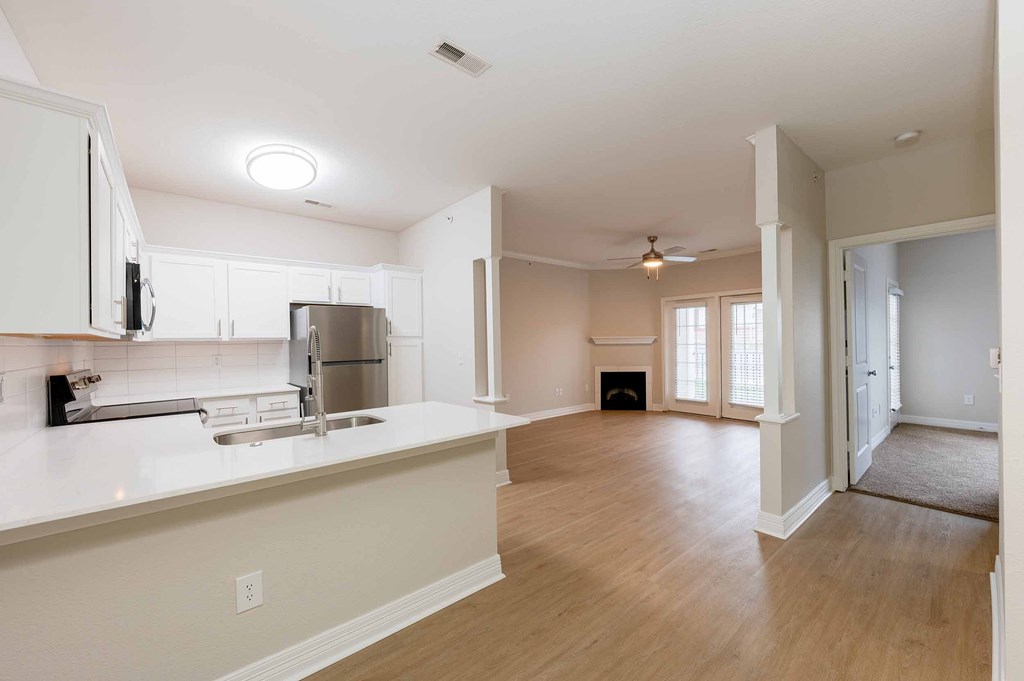 A kitchen with a sink and a stove top oven.