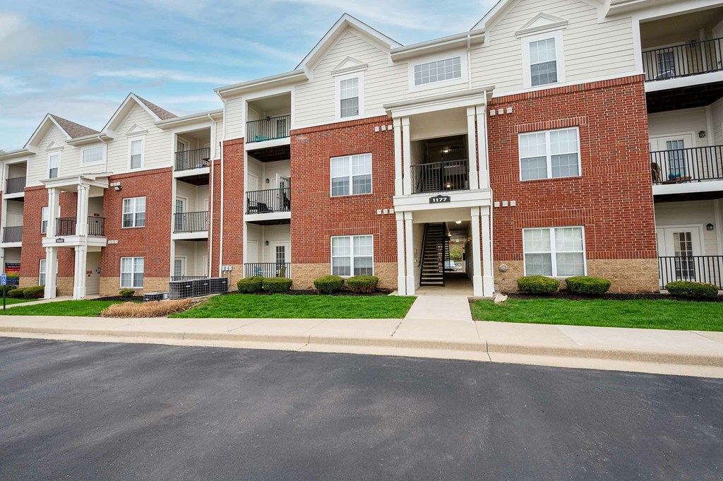 Apartment building with a red brick facade and white trim.