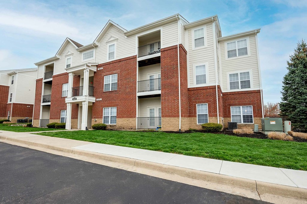 A large apartment complex with multiple balconies and doors.