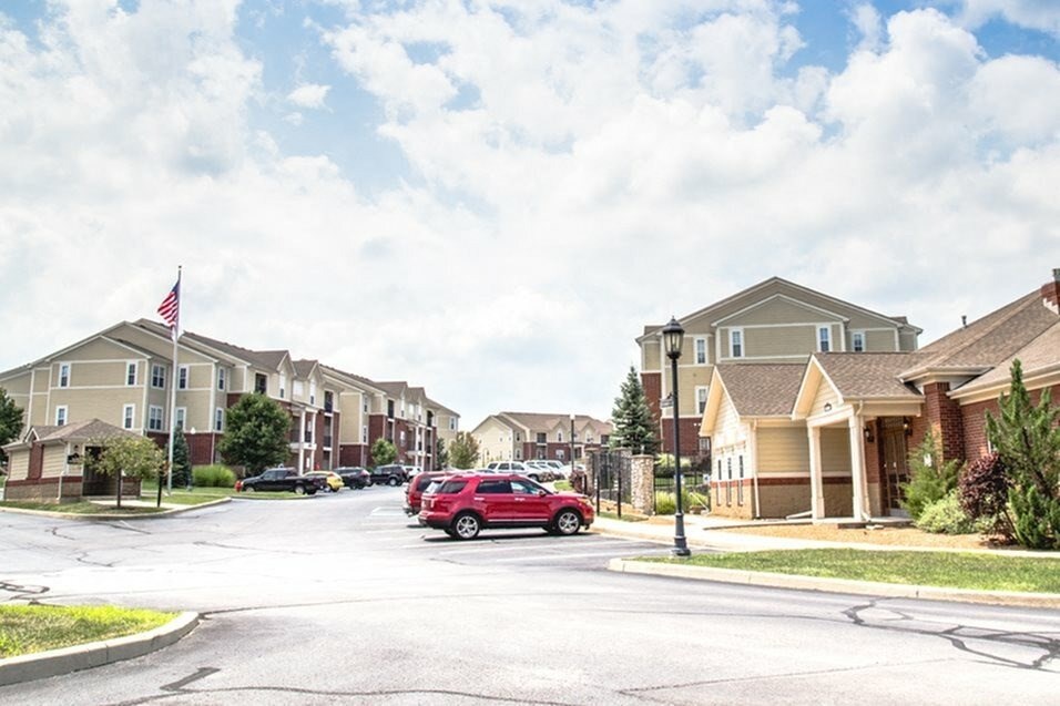 a red car parked on a street in front of houses