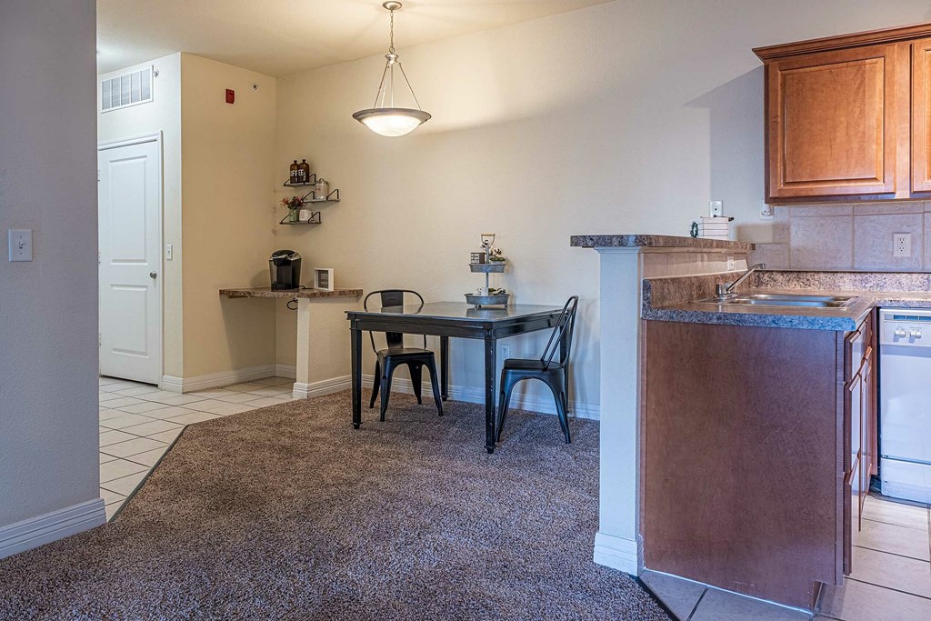a living room with a stone fireplace and chairs