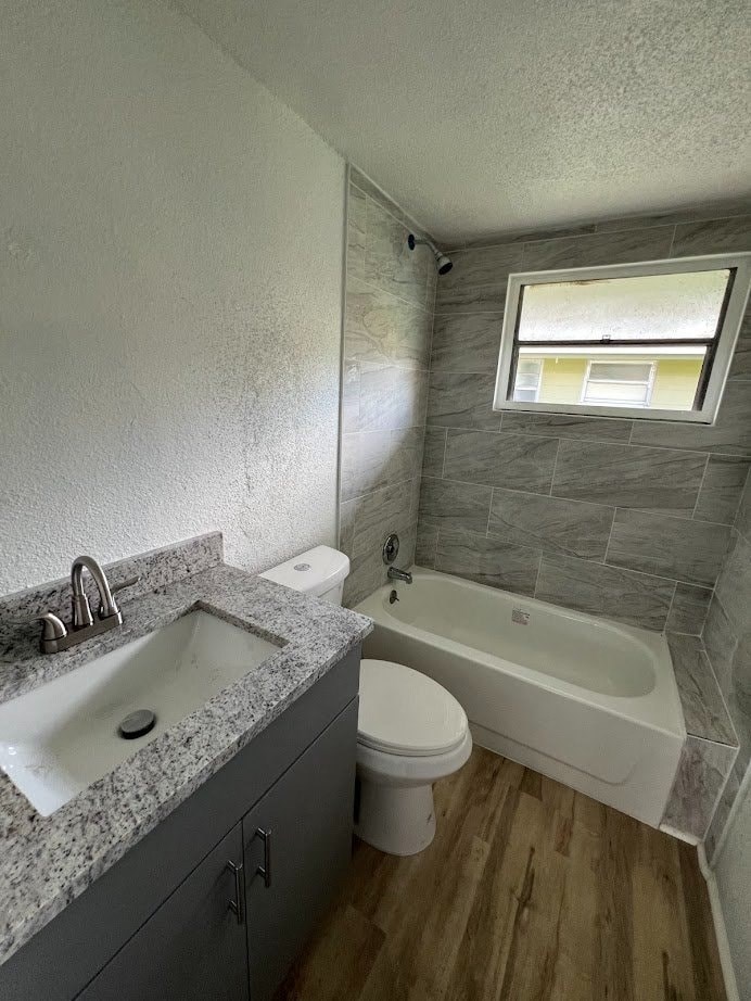 A bathroom with a sink, toilet, and bathtub.