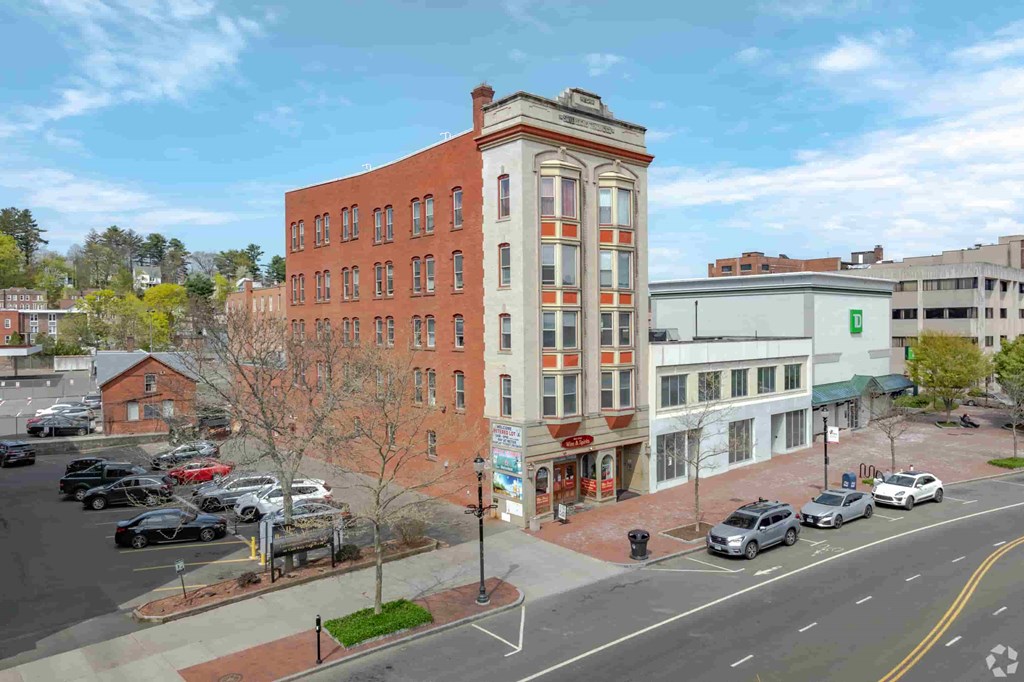 A street view of a city with cars and buildings.