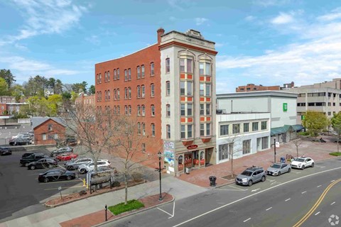 A street view of a city with cars and buildings.