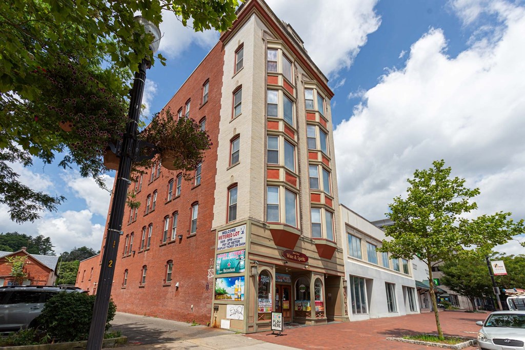 A red brick building with a white trim and a sign that says "Bakery".