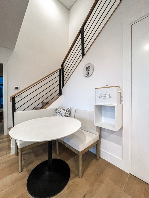 a small dining room with a white table and a chair