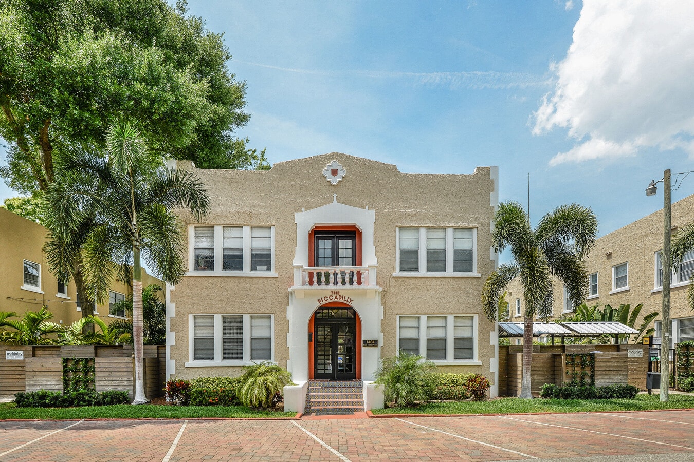 a large brick house with palm trees in front of it