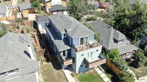 an aerial view of a house with a roof and a deck