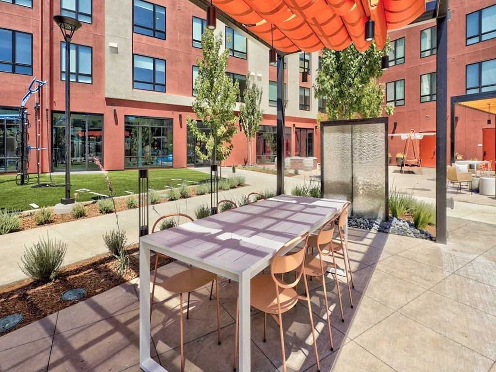 a long table with chairs in front of a building