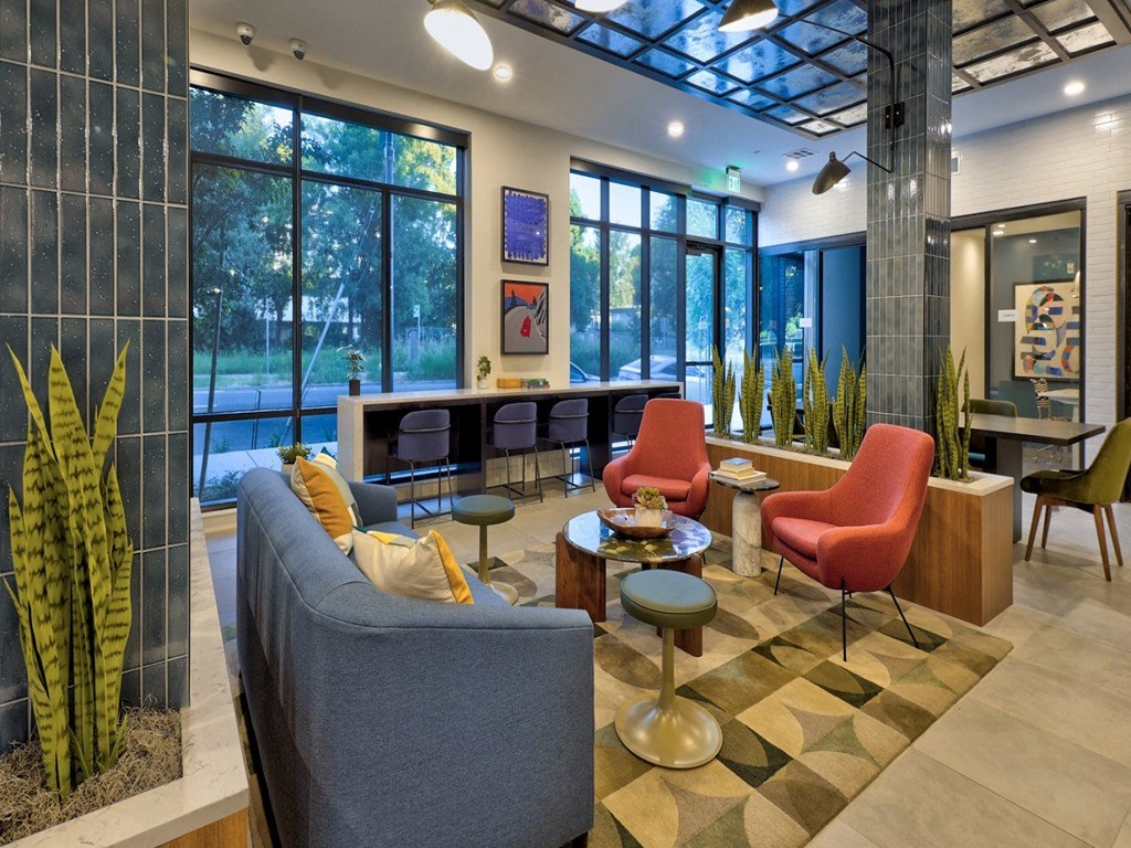 a living room with a couch and chairs in a lobby