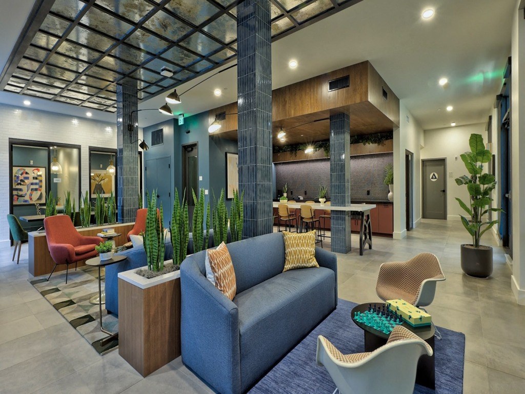 a lobby with couches and chairs and a table