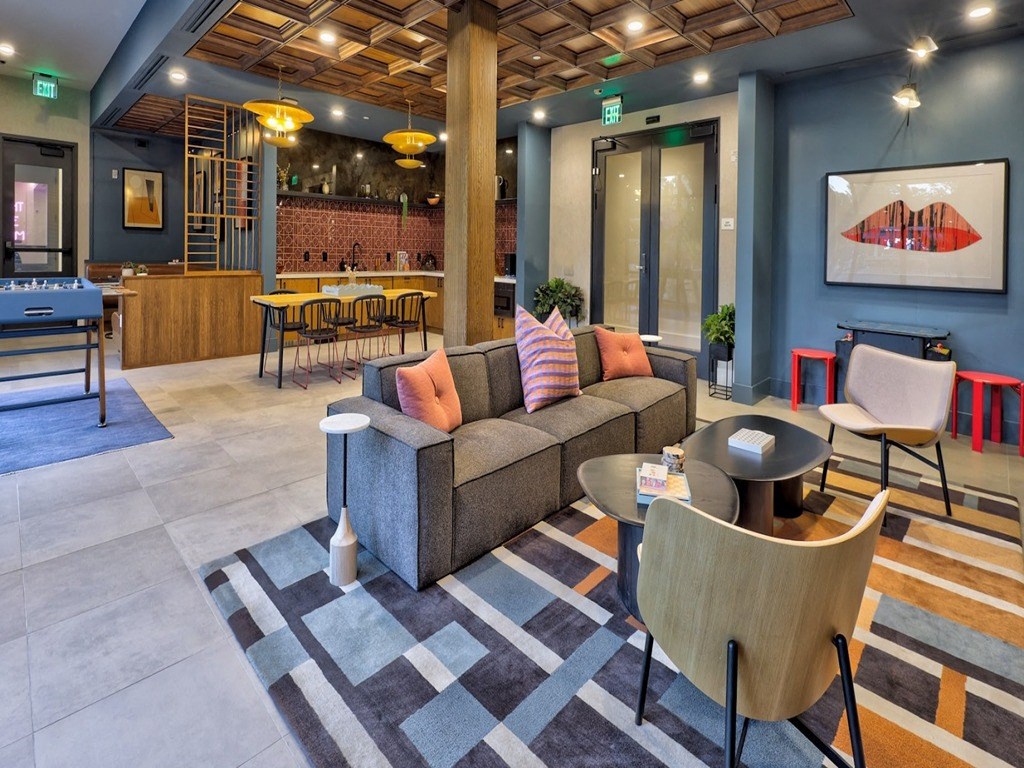 a living room with couches and chairs and a bar