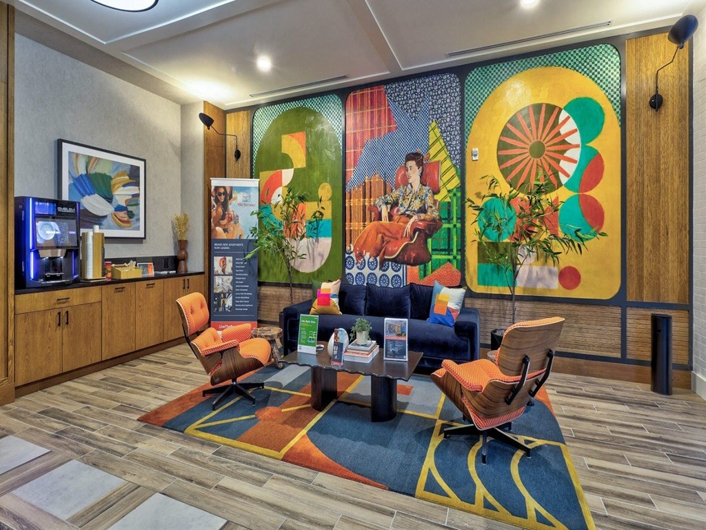 the lobby of a hotel with a colorful mural on the wall