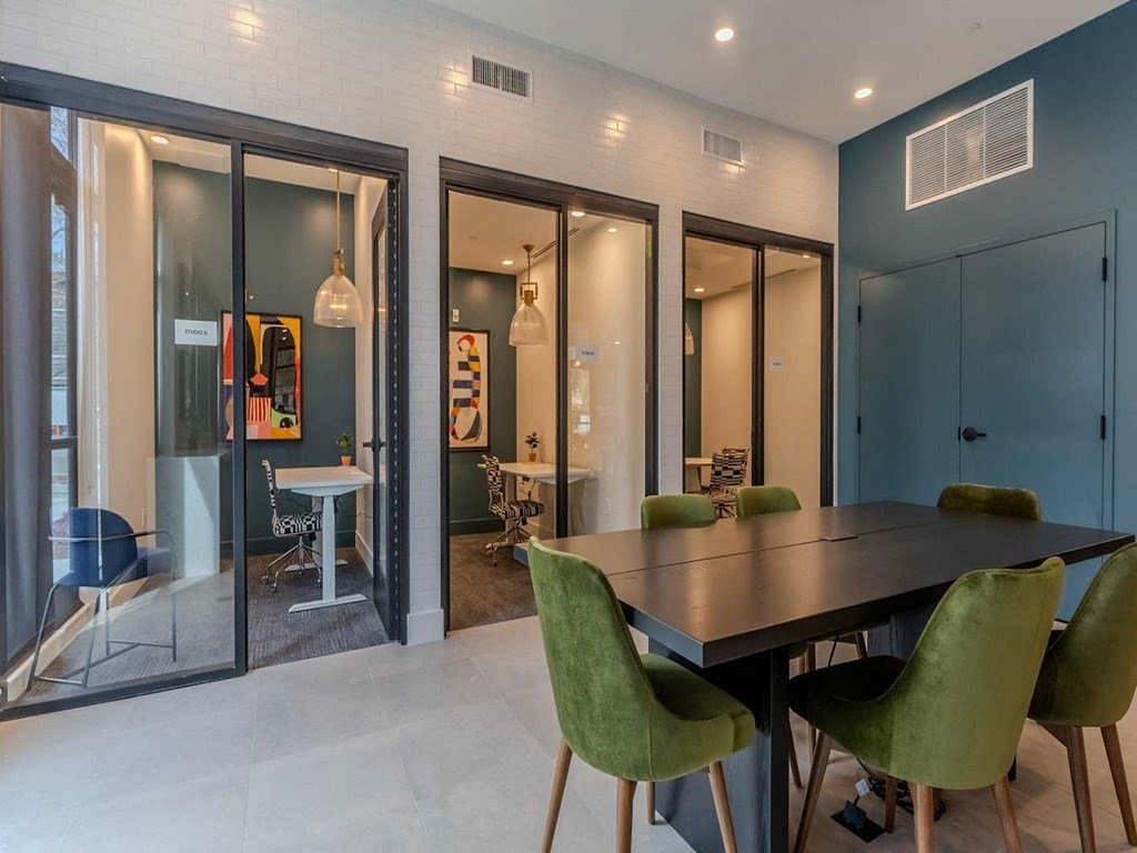 a dining area with a table and chairs and glass doors
