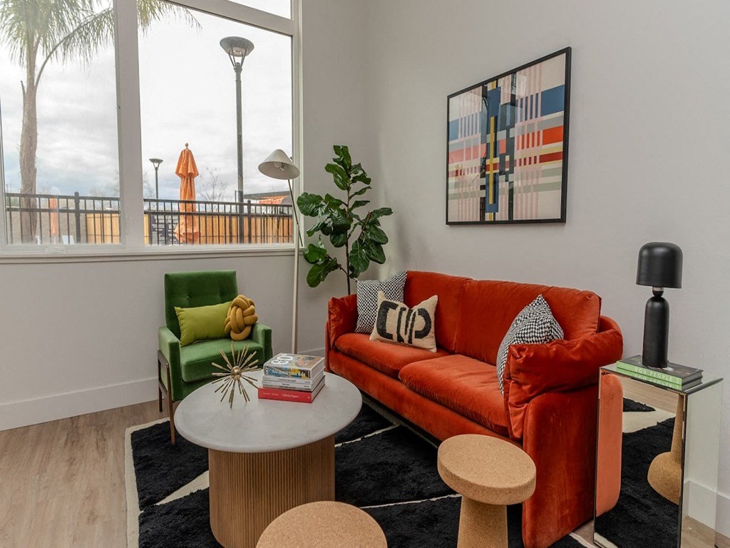 a living room with a couch and a table and a balcony