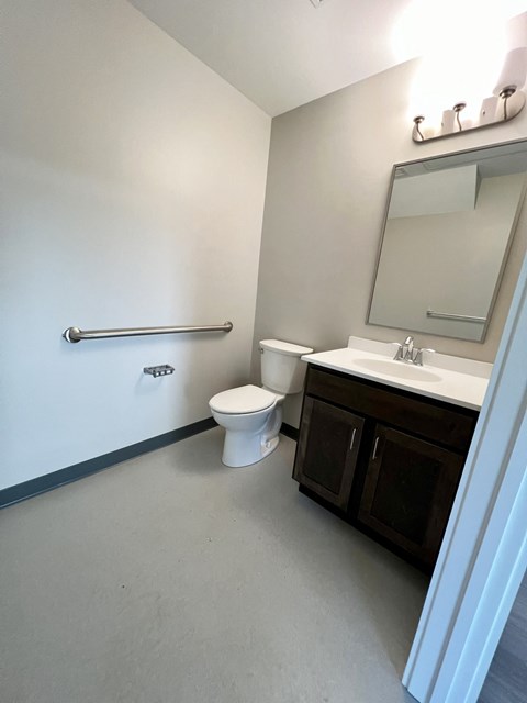 A white toilet sits next to a sink in a bathroom.