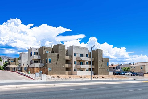 A modern apartment complex with a clear blue sky above.