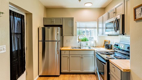 A kitchen with a stainless steel refrigerator and oven.