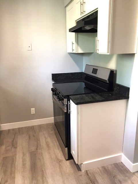 A black and white kitchen with a stove and oven.