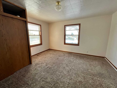 a bedroom with a wardrobe and a carpeted floor