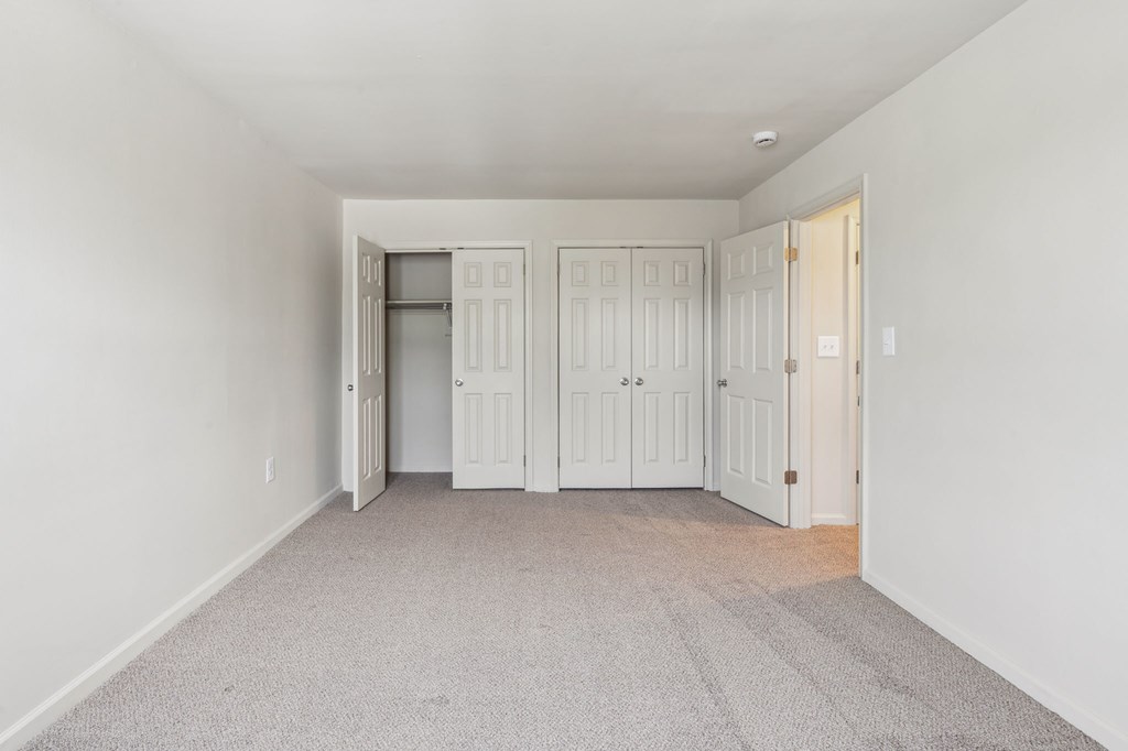 a living room and dining room with a table and chairs
