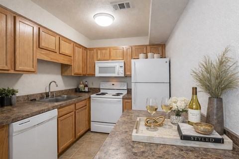 a kitchen with white appliances and wooden cabinets