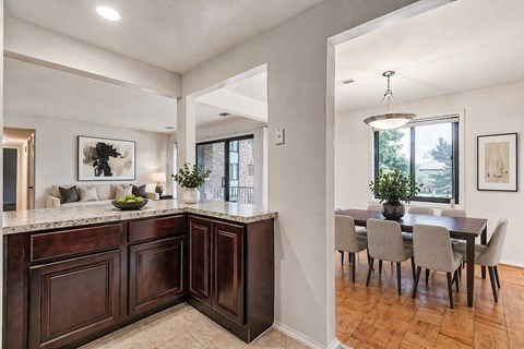 a kitchen with stainless steel appliances and dark wood cabinets
