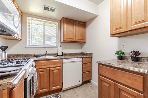 a white stove top oven in a kitchen with a microwave above it