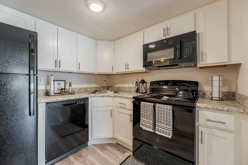 A black stove top oven with a towel hanging on it.