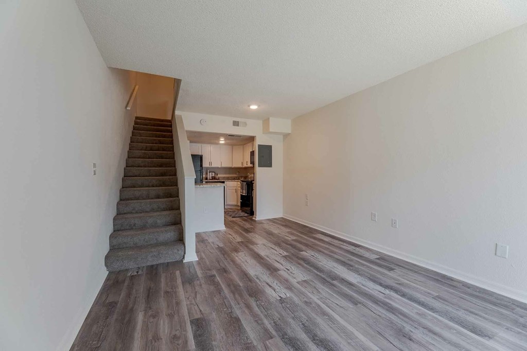 A room with a staircase leading to the upper floor.