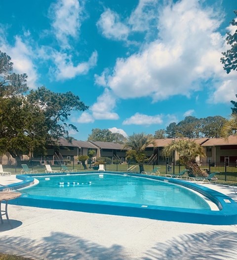 a swimming pool with houses in the background