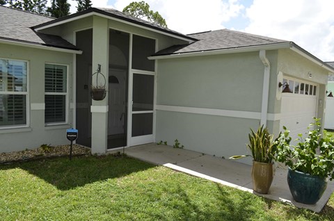 the front of the house has a walkway and a porch
