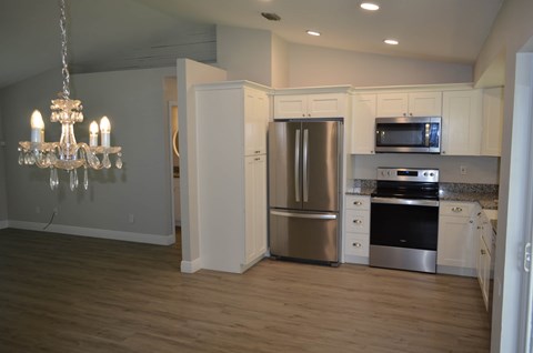 a kitchen with stainless steel appliances and a chandelier