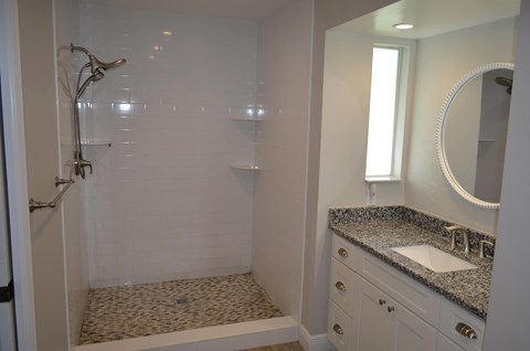 a small bathroom with a shower and a sink