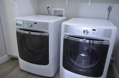 a washer and dryer are next to each other in a room
