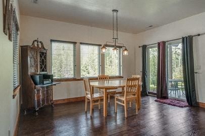 a dining room with a wooden table and chairs