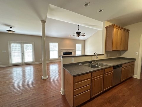 A kitchen with wooden cabinets and a ceiling fan.