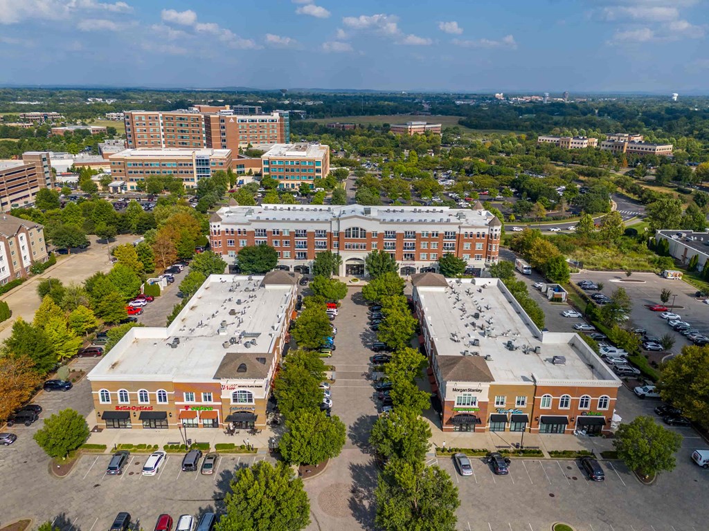 A large building complex with a parking lot in front.