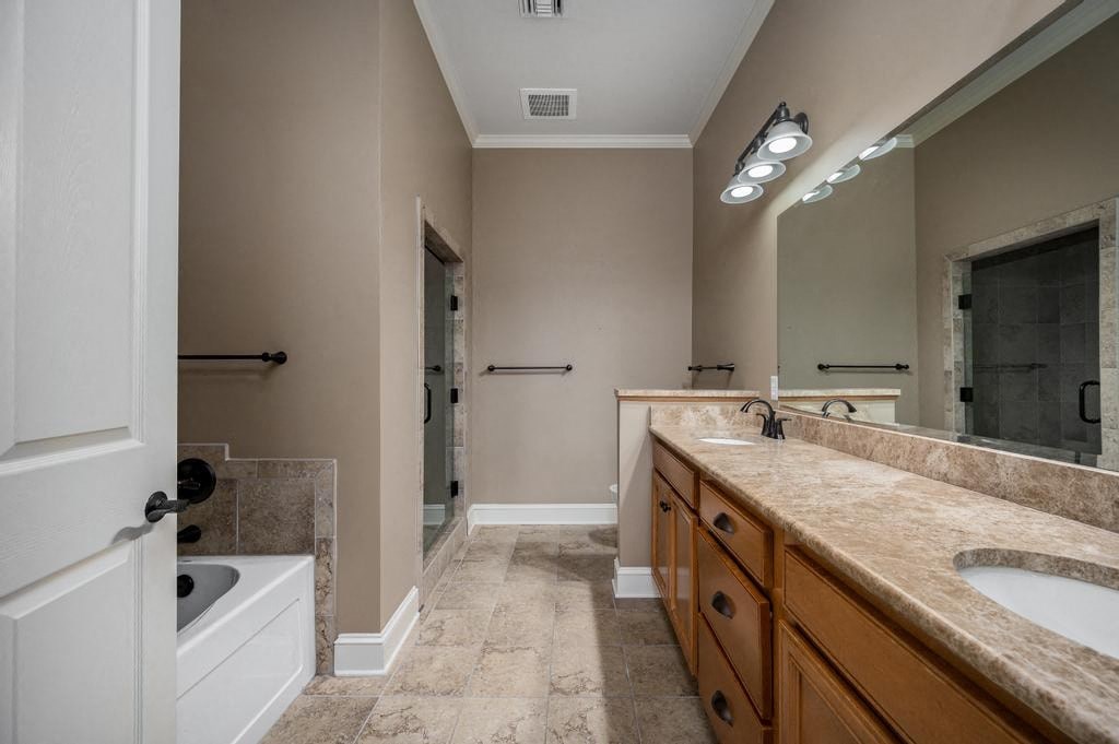 A bathroom with a marble countertop and a walk-in shower.