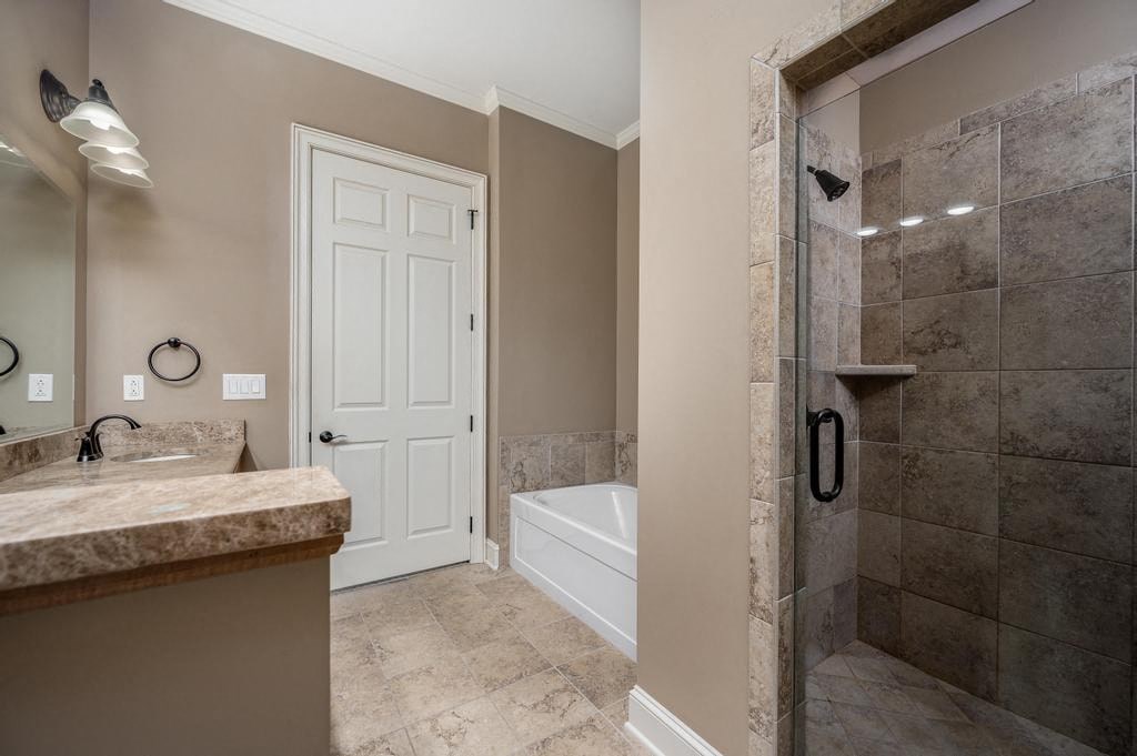 A bathroom with a white door and a marble countertop.