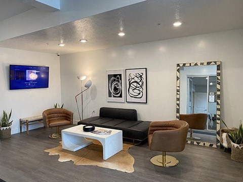 A modern living room with a white coffee table and a flat screen TV mounted on the wall.