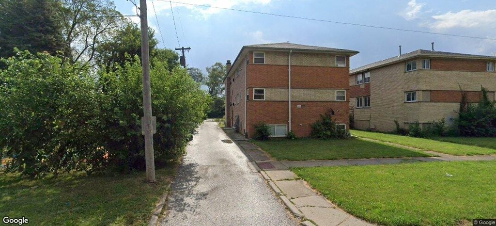 a street with two buildings on the side of a road