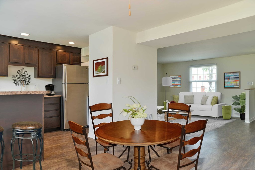a kitchen and dining room with a table and chairs